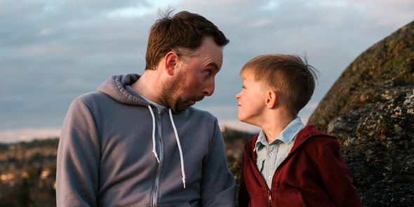 Far og sønn lager morsomme ansikter. En gøy fotoknudsen gaveidé til farsdagen for en leken pappa.